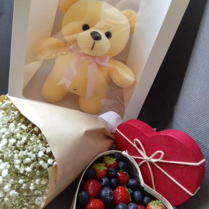 Мишка с ягодами и букетом цветов в общей упаковке